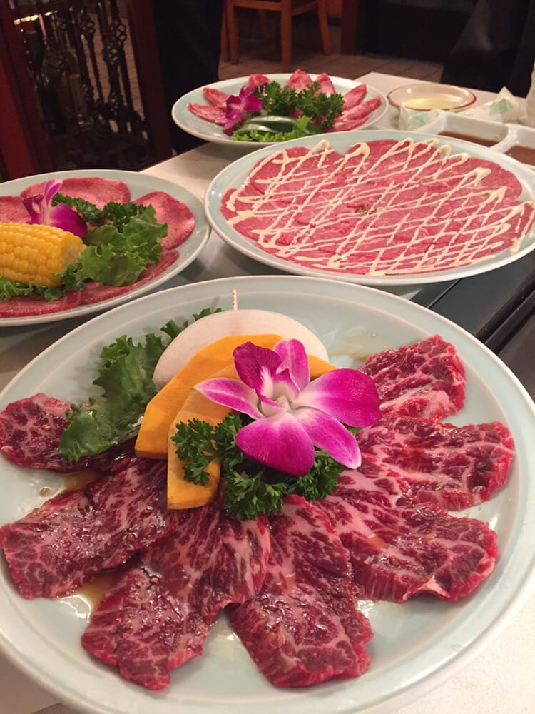 Marbled short rib slices being grilled tableside