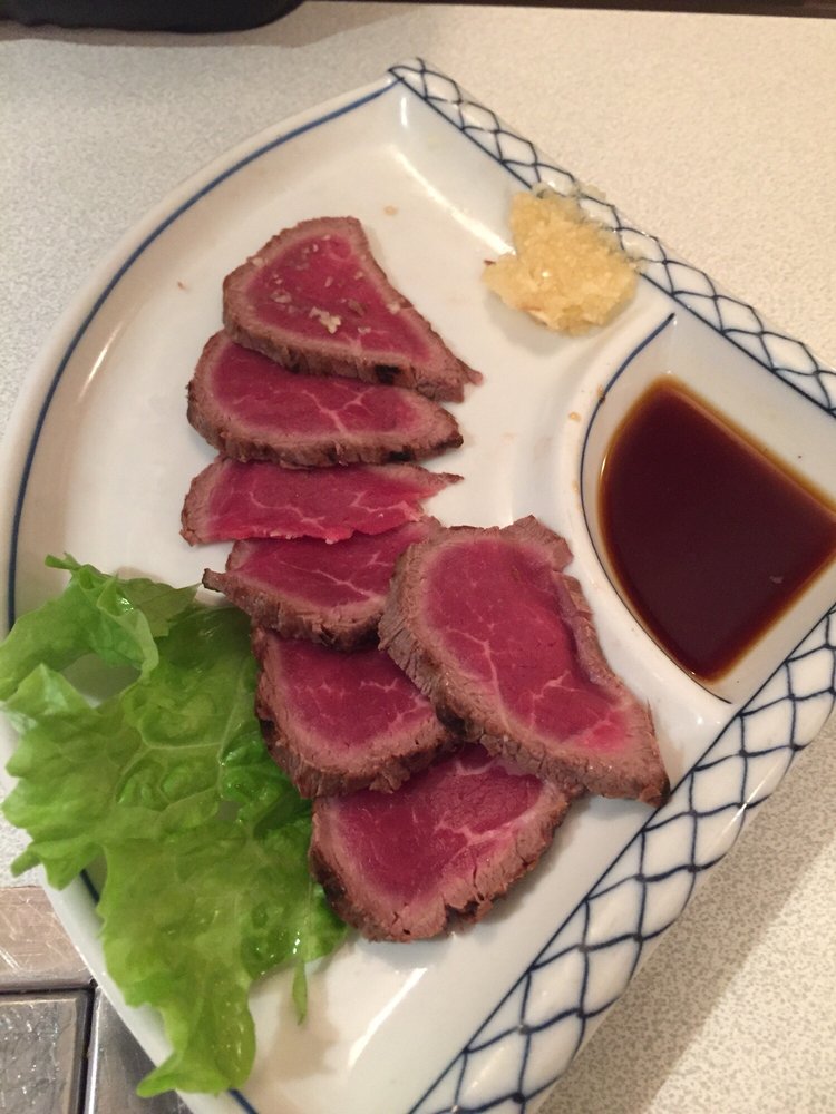 Grilled seafood and meats on the tabletop charcoal grill